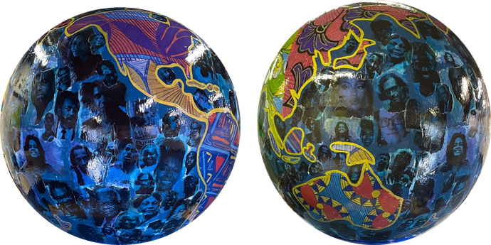 Two globe art sculptures with images of Black Britons on them. 