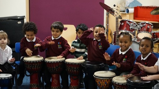 Pupils playing bongo drums