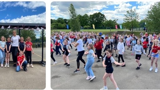 An image of a large number of young pupils dancing on their playground.