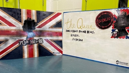 Two hand-drawn pieces of art, inspired by the punk movement. One is a union jack and the other is a large scale letter addressed to the Queen.