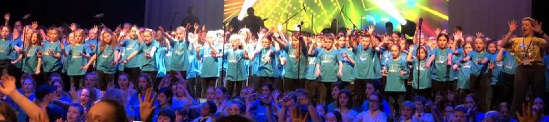 Children singing on stage in a concert