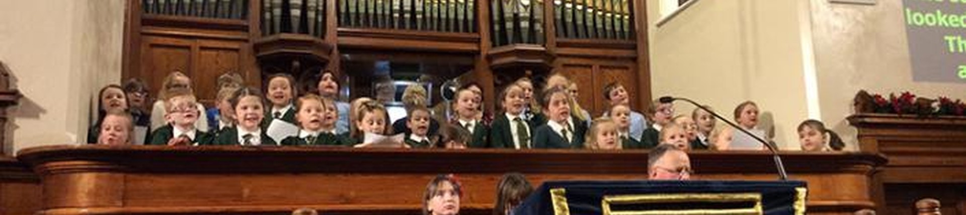 Pupils in singing in a choir in a church setting 