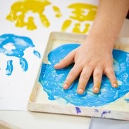 Child hand on painting